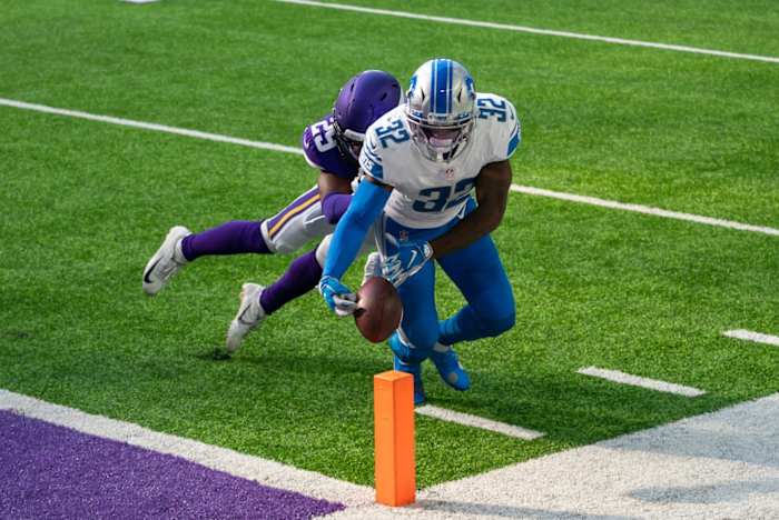 Swift is tackled by Minnesota Vikings defensive back Kris Boyd.